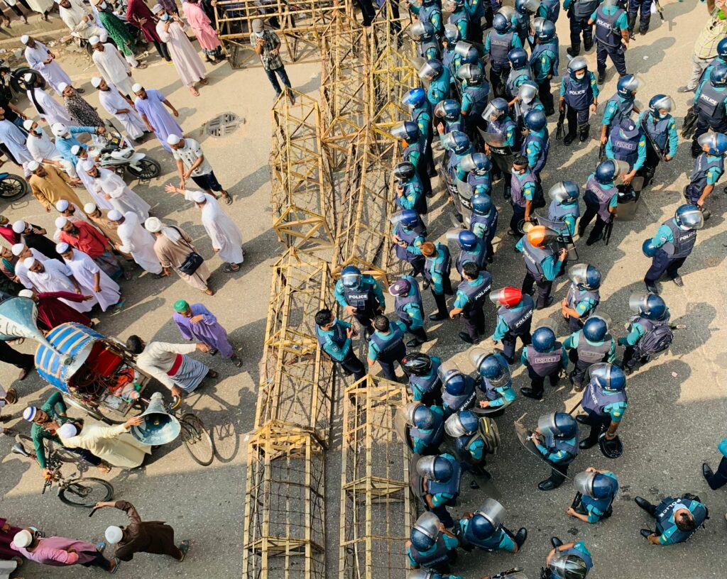Aerial view of protestors and police officers facing off in Dhaka, Bangladesh.